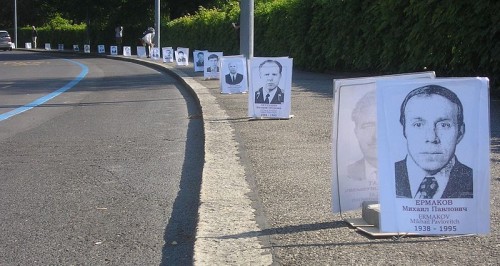 Intervenção pública em frente à sede da Organização Mundial da Saúde, com retratos de 